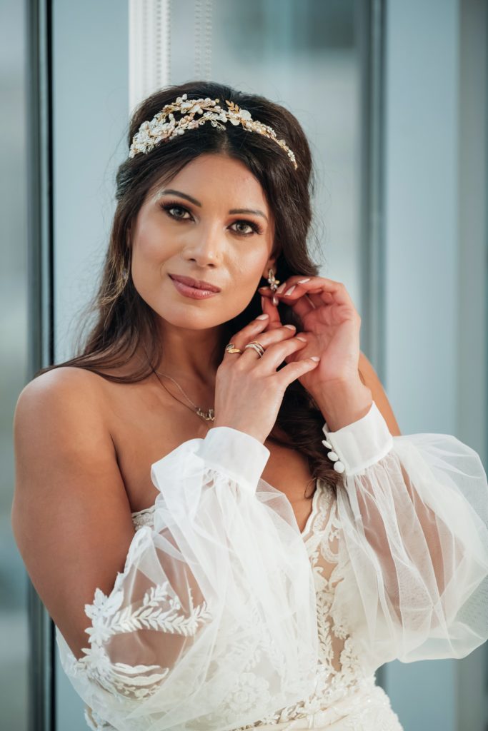 Bride putting earrings on  | Weddings & Events by Cheryl Munro | Toronto Wedding Planner