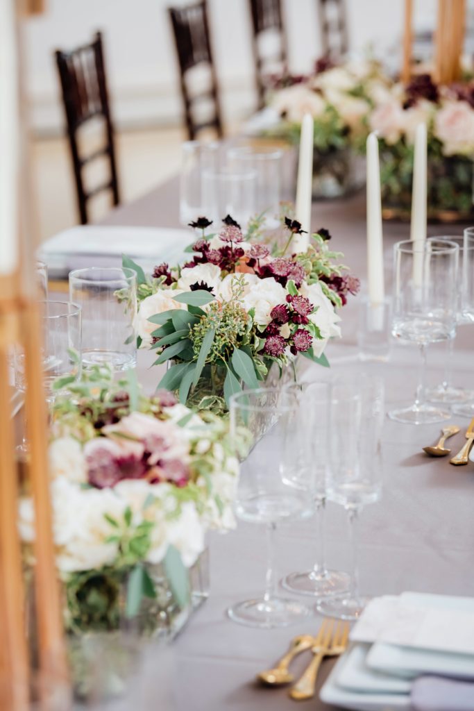 Burgundy and white flower arrangements on a table | Weddings & Events by Cheryl Munro | Toronto Wedding Planner