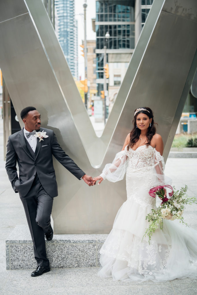 Bride and groom holding hands outside  | Weddings & Events by Cheryl Munro | Toronto Wedding Planner