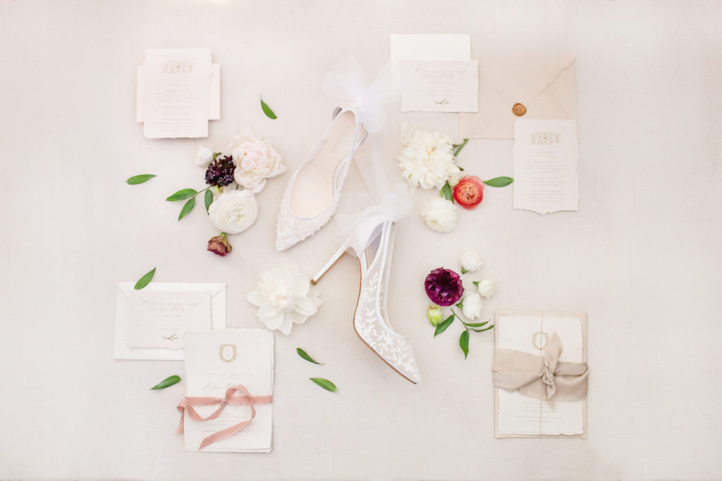 Flatlay with wedding invitations, flowers and bride shoes  | Weddings & Events by Cheryl Munro | Toronto Wedding Planner