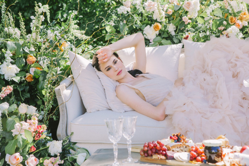 Bride laying on a couch with her arm on her head  | Weddings & Events by Cheryl Munro | Toronto Wedding Planner