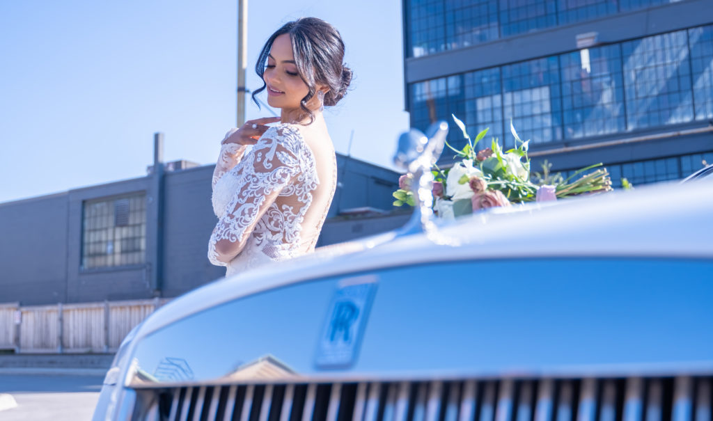 Bride with flowers and rolls royce  | Weddings & Events by Cheryl Munro | Toronto Wedding Planner