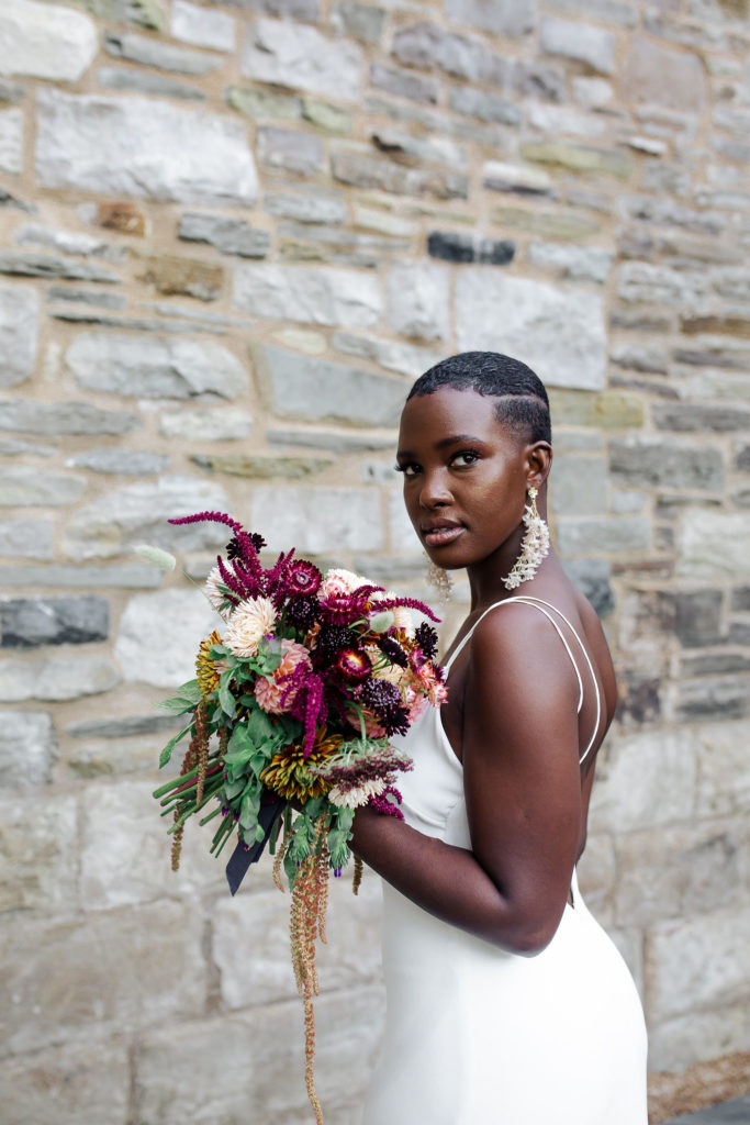 Bride holding rustic floral bouquet| Weddings & Events by Cheryl Munro | Toronto Wedding Planner