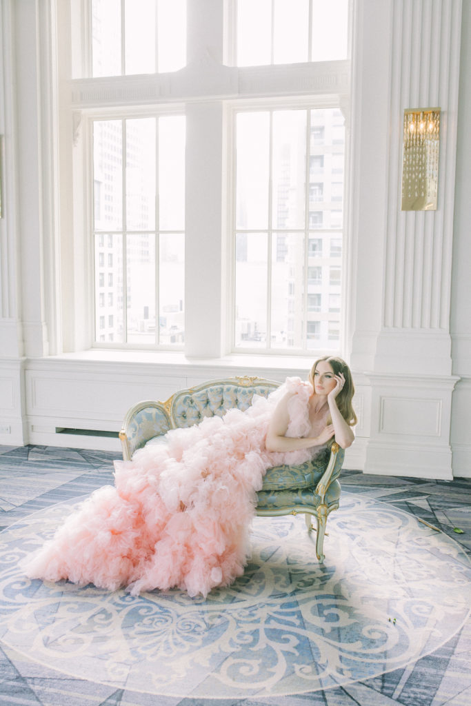 Bride in pink ruffle dress laying in chair  | Weddings & Events by Cheryl Munro | Toronto Wedding Planner