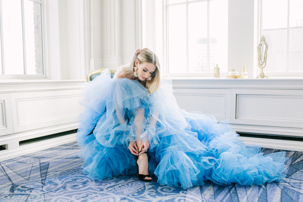 Bride in blue ruffle dress putting shoes on  | Weddings & Events by Cheryl Munro | Toronto Wedding Planner