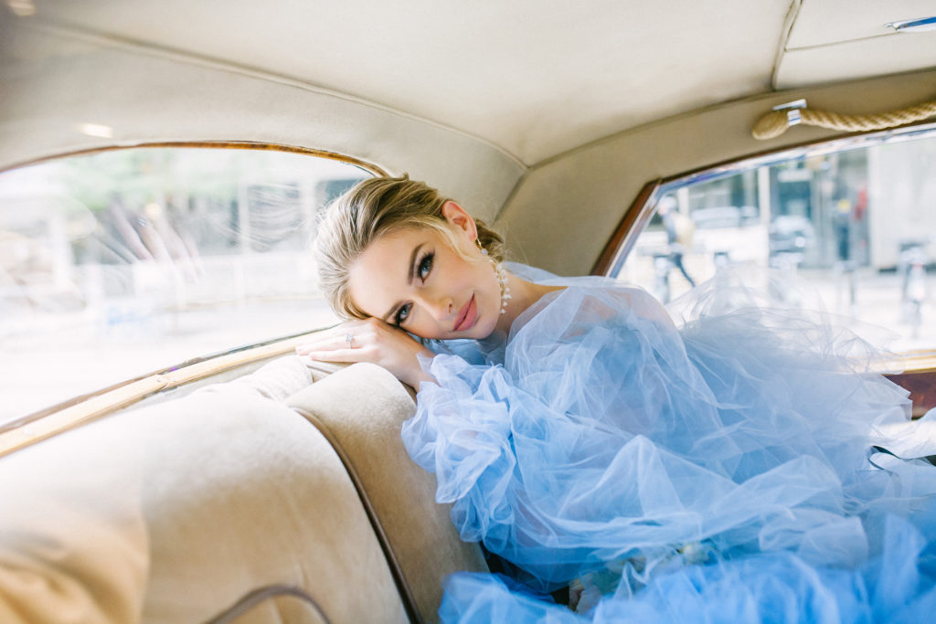 Bride in blue ruffle dress sitting in a rolls royce  | Weddings & Events by Cheryl Munro | Toronto Wedding Planner