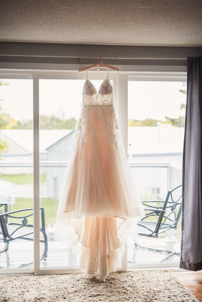 Bride dress hanging in window | Weddings & Events by Cheryl Munro | Toronto Wedding Planner